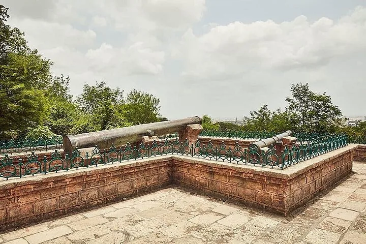 ancient cannons mounted on a stone platform overlooking the surroundings