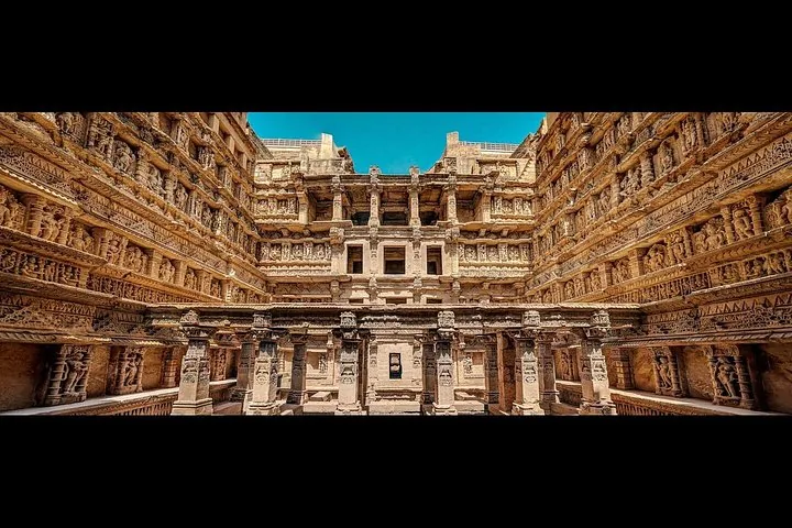 intricate carvings covering the walls of an ancient stepwell structure
